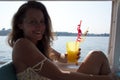 Happy young woman drink summer cocktail on sea background Royalty Free Stock Photo