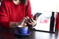 Happy young woman drinking cappuccino, latte, macchiato, tea, using tablet computer and talking on the phone in a coffee shop / ba Royalty Free Stock Photo