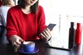 Happy young woman drinking cappuccino, latte, macchiato, tea, using tablet computer and talking on the phone in a coffee shop / ba Royalty Free Stock Photo