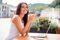 Happy young woman drinking coffe in a cafe and dreaming Royalty Free Stock Photo