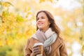 Happy young woman drinking coffee in autumn park Royalty Free Stock Photo