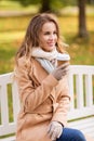 Happy young woman drinking coffee in autumn park Royalty Free Stock Photo