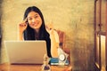 Happy young woman drinking coffee / tea and using laptop Royalty Free Stock Photo