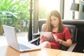 Happy young woman drinking coffee / tea and using tablet computer Royalty Free Stock Photo