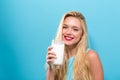Happy young woman drinking milk on a solid background Royalty Free Stock Photo