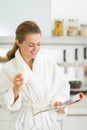 Happy young woman drinking milk in kitchen Royalty Free Stock Photo