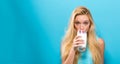 Happy young woman drinking milk on a solid background Royalty Free Stock Photo