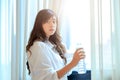 Happy young woman drinking pure water on her bedroom. concept for healthy