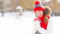 Happy young woman drinking tea in winter