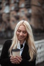 happy young woman drinks coffee in break. girl take coffee and go to work Royalty Free Stock Photo