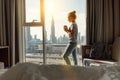 Happy young woman drinks coffee in morning at window Royalty Free Stock Photo