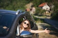 Happy young woman driver driving car on country road Royalty Free Stock Photo