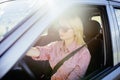 Happy young woman driver driving her new luxury car Royalty Free Stock Photo