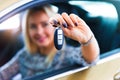 Happy woman driver holding auto keys in her car Royalty Free Stock Photo