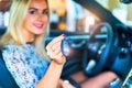 Happy woman driver holding auto keys in her car Royalty Free Stock Photo