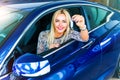 Happy woman driver holding auto keys in her car Royalty Free Stock Photo