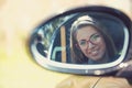 Woman driver looking in the side view mirror of her new car Royalty Free Stock Photo