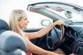 Happy young woman driving convertible car Royalty Free Stock Photo