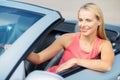 Happy young woman driving convertible car Royalty Free Stock Photo