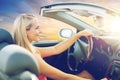 Happy young woman driving convertible car Royalty Free Stock Photo