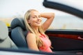 Happy young woman driving convertible car Royalty Free Stock Photo