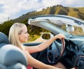 Happy young woman driving convertible car Royalty Free Stock Photo