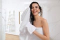 Happy young woman drying hair with towel after washing in bathroom Royalty Free Stock Photo