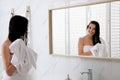 Happy young woman hair with towel after washing near mirror in bathroom Royalty Free Stock Photo