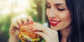 Happy young woman eat tasty fast food burger Royalty Free Stock Photo