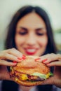 Happy young woman eat tasty fast food burger Royalty Free Stock Photo