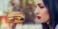 Happy young woman eat tasty fast food burger Royalty Free Stock Photo