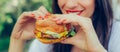 Happy young woman eat tasty fast food burger Royalty Free Stock Photo