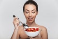 happy young woman eating cereal breakfast with strawberries Royalty Free Stock Photo