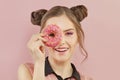 Happy young woman eating donut, sweet funny portrait