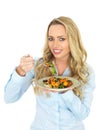 Happy Young Woman Eating a Healthy Roast Vegetable Salad Meal Royalty Free Stock Photo