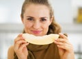 Happy young woman eating melon