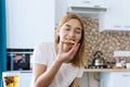 Happy young woman eating a piece of hot pizza at home and enjoying a delicious meal Royalty Free Stock Photo