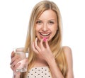 Happy young woman eating pill Royalty Free Stock Photo