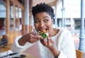 Happy young woman eating pizza at restaurant Royalty Free Stock Photo