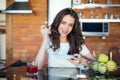 Happy young woman eating breakfast in the kitchen Royalty Free Stock Photo