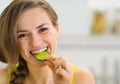 Happy young woman eating slice of cucumber Royalty Free Stock Photo