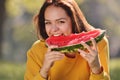 Happy young woman eating watermelon in the park. Royalty Free Stock Photo