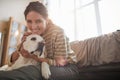 Happy Young Woman Embracing Dog at Home Royalty Free Stock Photo