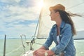 Happy young woman enjoying cruising on sailboat on a sunny cloudy summer day Royalty Free Stock Photo