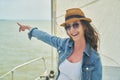 Happy young woman enjoying cruising on sailboat on a sunny cloudy summer day Royalty Free Stock Photo