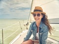 Happy young woman enjoying cruising on sailboat on a sunny cloudy summer day Royalty Free Stock Photo