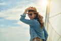 Happy young woman enjoying cruising on sailboat on a sunny cloudy summer day Royalty Free Stock Photo