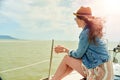 Happy young woman enjoying cruising on sailboat on a sunny cloudy summer day Royalty Free Stock Photo
