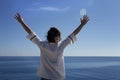 a happy young woman enjoying freedom with her hands open at sea Royalty Free Stock Photo