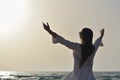 happy young woman enjoying freedom with open hands on sea Royalty Free Stock Photo